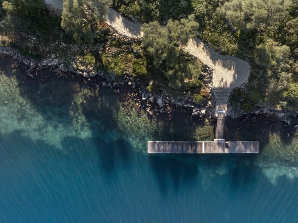 The magical path to the jetty and the crystal-clear waters of the Ionian Sea.